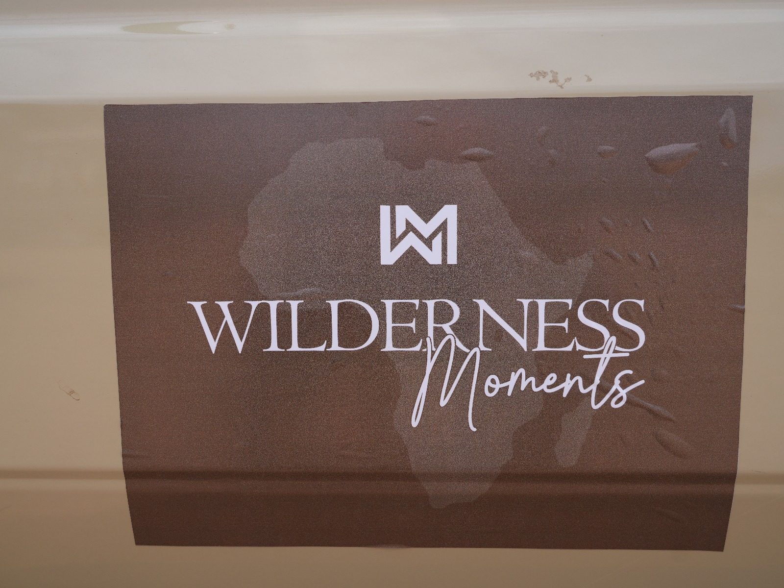 Guests and guide beside the Wilderness Moments safari vehicle